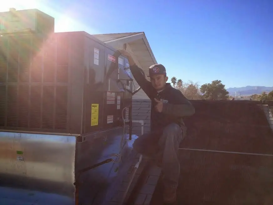 HVAC technician performing AC Tune-Up on a rooftop unit in Topanga